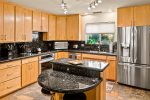 Warm, upgraded kitchen with granite and stainless steel appliances